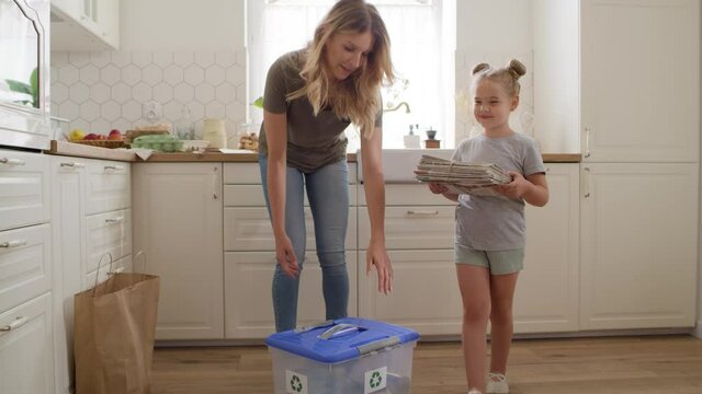 Video of mother and daughter taking out segregated garbage. Shot with RED helium camera in 8K