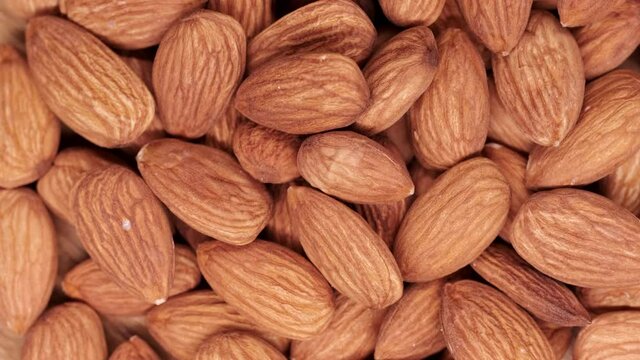 Top view of almonds. Almonds in slow motion on a moving platform