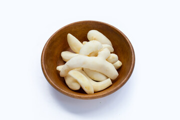 Young ginger peeled in wooden bowl on white background.