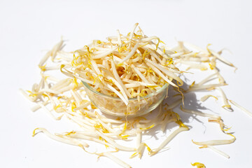 Bean sprouts in glass bowl on white background.