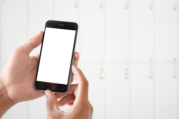 Cropped shot view of man hands holding smart phone with blank copy space screen for your text message or information content, female reading text message on cell telephone during in urban setting.