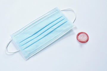 condom and hygienic mask for protection with sex activity on white background