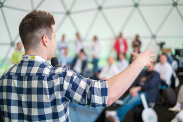 Startup male leader speaks at pitch session