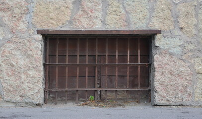 A basement window with a metal barrier