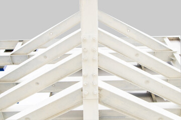 Fototapeta premium Large screw hexagon flange nut Supporting structures, metal frame of prefabricated building. Isolated on white background. large metal posts or structure are painted in white of outdoor billboard. 