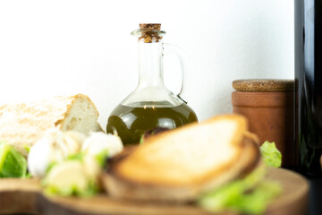 Close up of olive oil dispenser with bread in front for fettunta