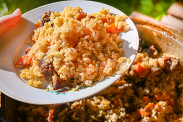Traditional oriental pilaf in a cauldron