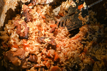 Traditional oriental pilaf in a cauldron