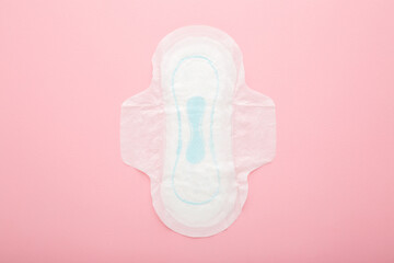 New opened white sanitary towel on light pink table background. Pastel color. Closeup. Female hygiene. Top down view. © fotoduets