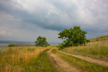 A country road in the steppe on the hills.