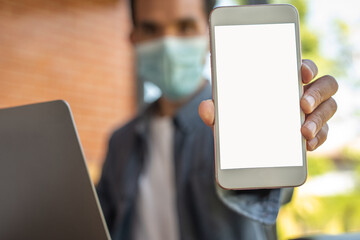 Man demonstrating new modern smartphone with a blank white screen for advertisement or application mockup