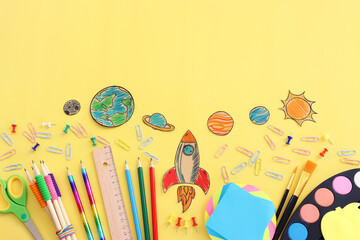 Back to school concept. Top view image of student stationery over pastel yellow background