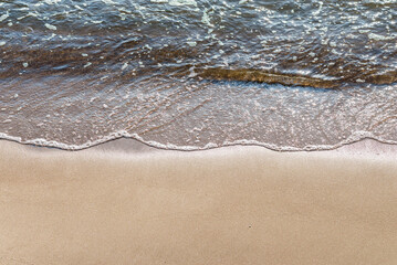 Fototapeta na wymiar Soft wave of the sea on the sandy beach.Soft focus,blurred image.