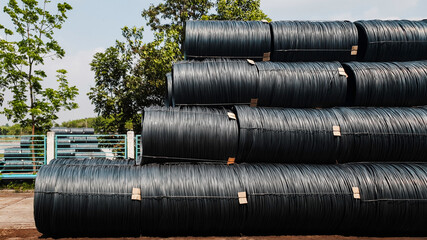 Stacked of high carbon wire rod for heavy industry production,Pile of metal steel wire roll for construction site, concrete usage and building construction