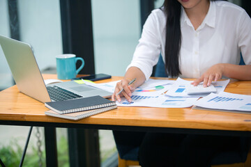 Portrait of Beautiful businesswoman sitting at desk and working with laptop computer.