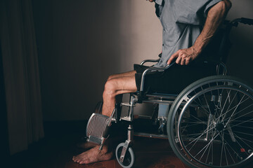 Obraz premium Lonely disabled man on wheelchair in the house, Depression occurs in people with disabilities who are alone at home...