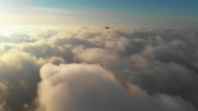 Generic jet airliner plane flying above the clouds at dawn. Realistic composite video with 3D rendering.