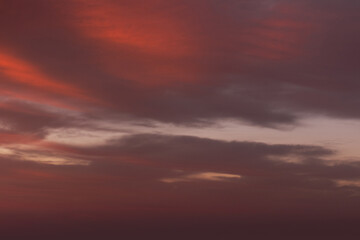 Sunrise sky with red color fire on a cloudy winter day. Space for text.