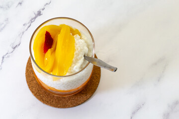 Sweet tapioca pudding with fresh mango and strawberry