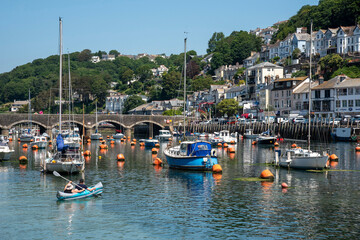 Looe, Cornwall, England, UK. 2021. East Looe a popular holiday resort and fishing centre in Cornwall, UK,  holiday makers in a kayak crossing River Looe on incoming tide.