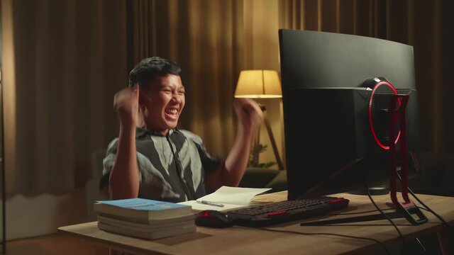 Young Asian Boy Student Celebrating With Computer At Home, Teenage Boy Learning Online
