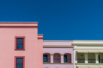 Colorful building facades against deep, bright blue sky
