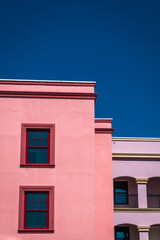 Colorful building facades against deep, bright blue sky
