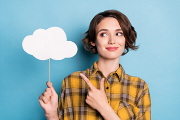 Photo of dream lady hold cloud stick direct finger empty space wear checkered shirt isolated blue color background
