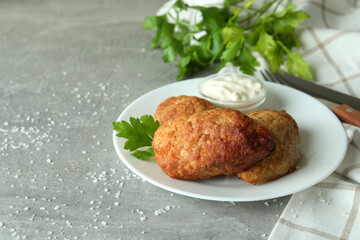 Concept of tasty food with cutlets on gray textured table