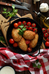 Concept of tasty food with cutlets on wooden table