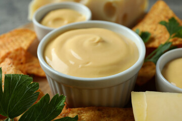 Concept of snack with chips and cheese sauce, close up