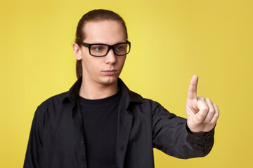 young man in glasses touching virtual screen