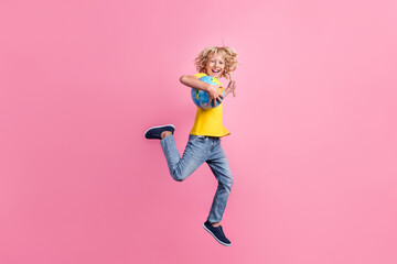 Full size profile side photo of school boy happy positive smile go jump hold globe stick isolated...