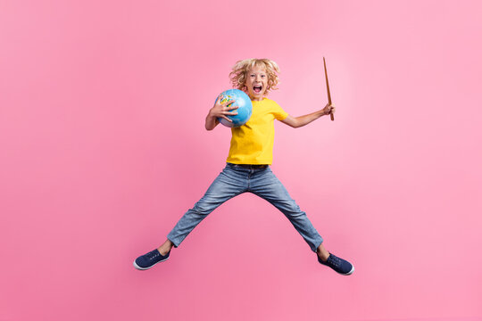 Full length photo of young school boy happy positive smile jump excited education planet stick isolated over pink color background