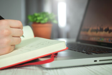 Young artist woman drawing in her notebook by using pencil, creative pencil art, artistic creative workspace background photo