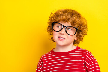 Photo of young dreamy happy charming boy look empty space wear glasses isolated on yellow color background