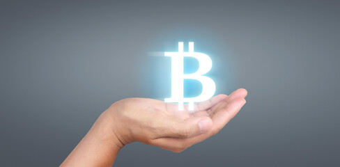 Hands showing bitcoin icon as virtual money digital