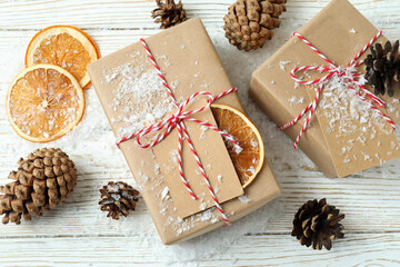 Gift boxes and Christmas accessories on white wooden table