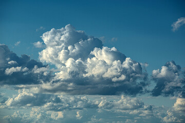 cumulus clouds in the blue sky above the earth