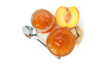 Jar and bowl of peach jam, ingredients and spoon isolated on white background
