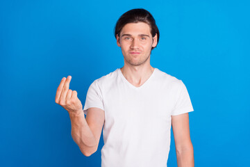 Photo of young positive charming man make fingers money sign ask demand isolated on blue color...