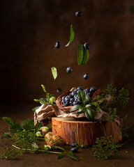 Still life with blueberries and green leaves