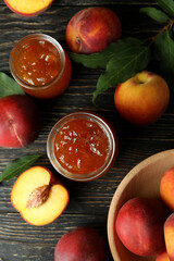 Peach jam and ingredients on rustic wooden table