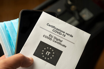 Man shows the paper version of his EU digital covid certificate