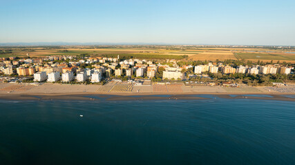 Aerial view of sandy beach with umbrellas and gazebos.Summer vacation concept.Lido Adriano...