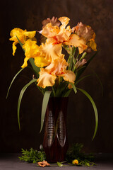 Bouquet of beautiful irises in an old glass vase