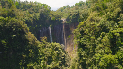 beautiful waterfall Coban Sewu in tropical forest, Java Indonesia. aerial view tumpak sewu waterfall in rainforest