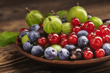  bowl of mint, nuts, berries, oatmeal and raisins.