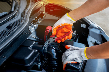 The mechanic uses pliers to check the condition of the car and fix the car.