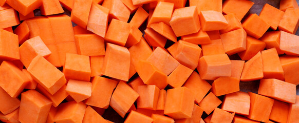 Web banner with diced sweet potato. Ingredient for a meal. Food texture  - 450544199